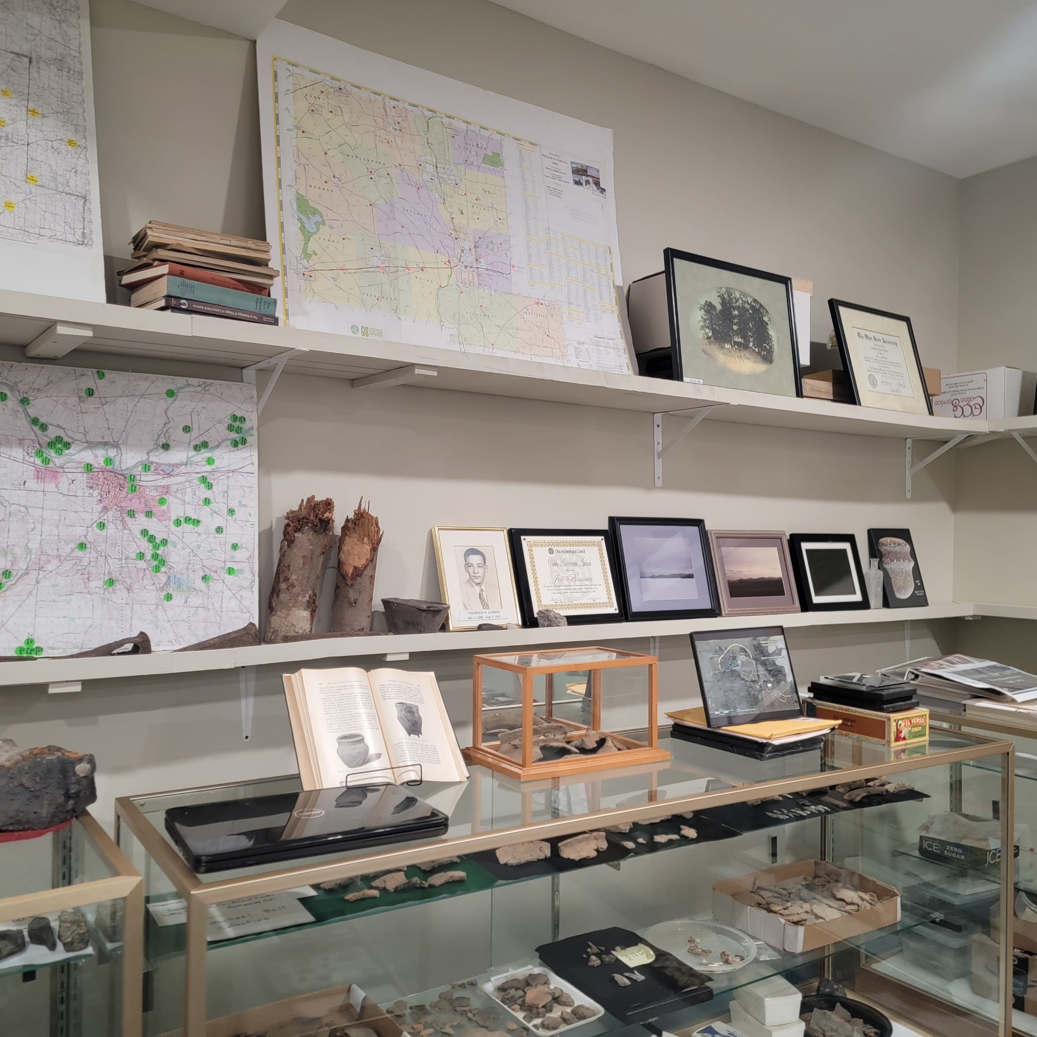 Archaeology room with county maps, artifacts and display cases