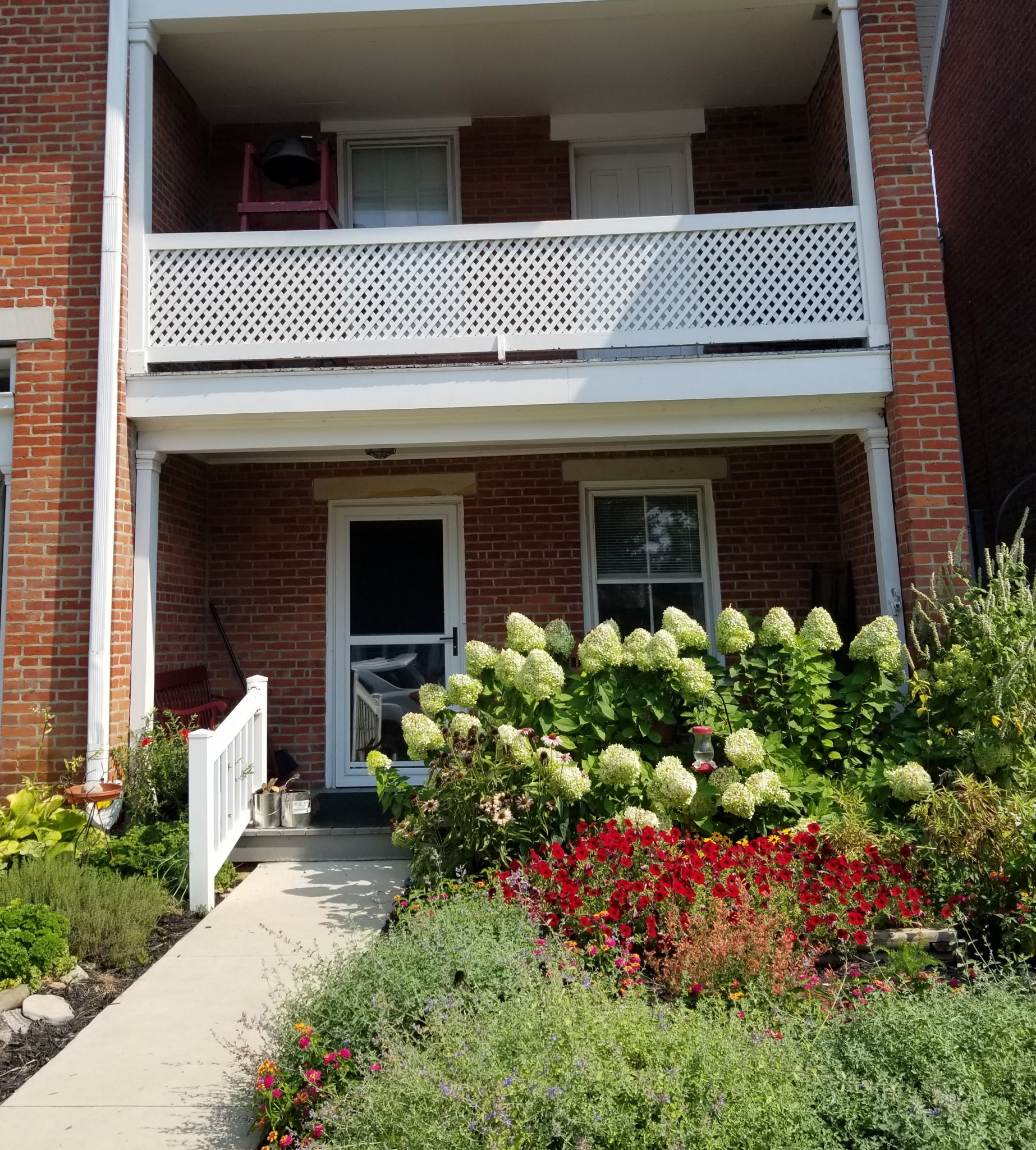 The museum porch and balcony with hydrangeas in bloom