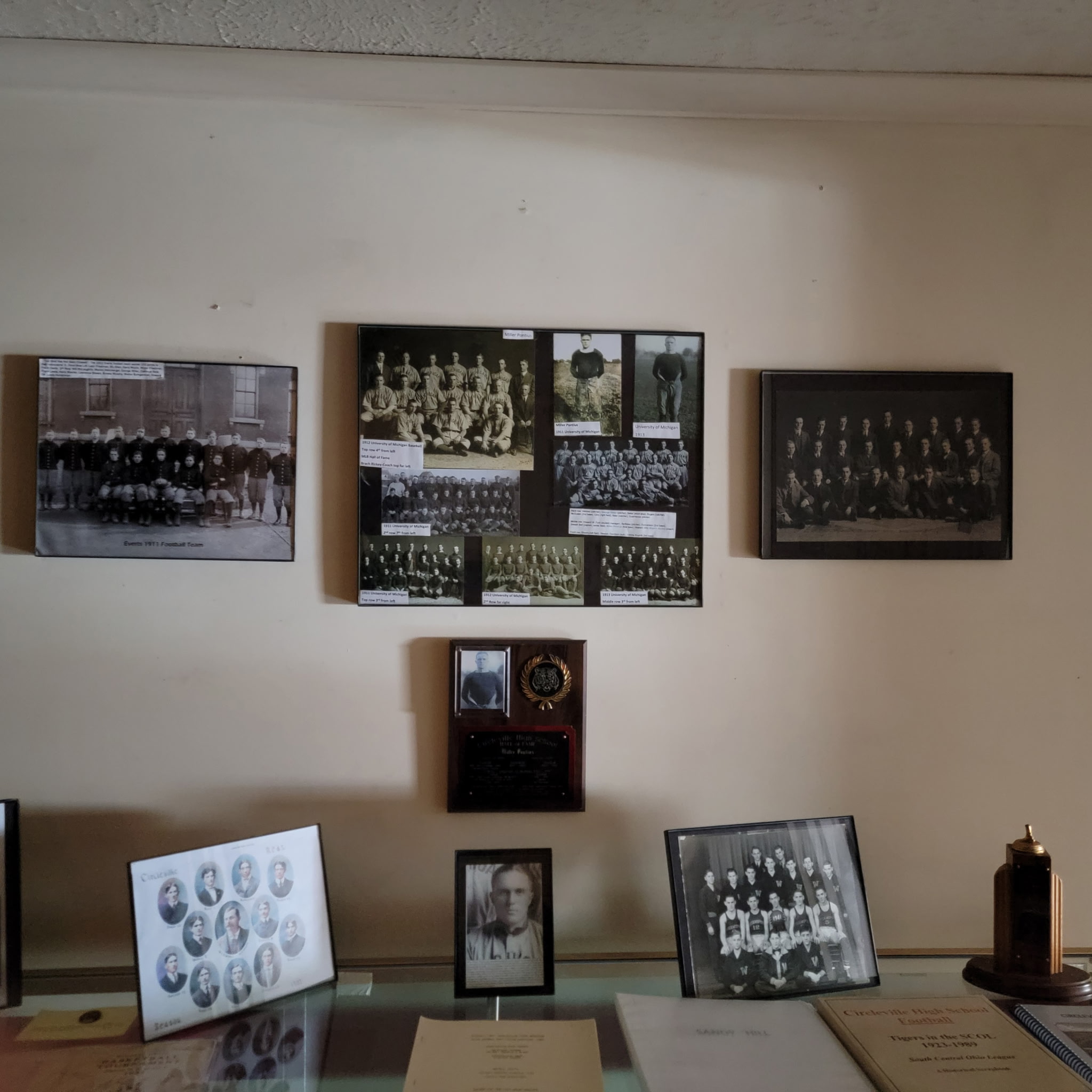 Wall of early Circleville team photographs and athletic memorabilia