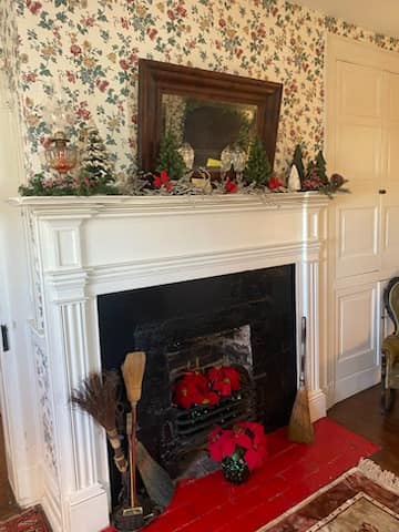 The Mount Oval parlor decorated for Christmas with a trimmed tree and a pianist at the piano