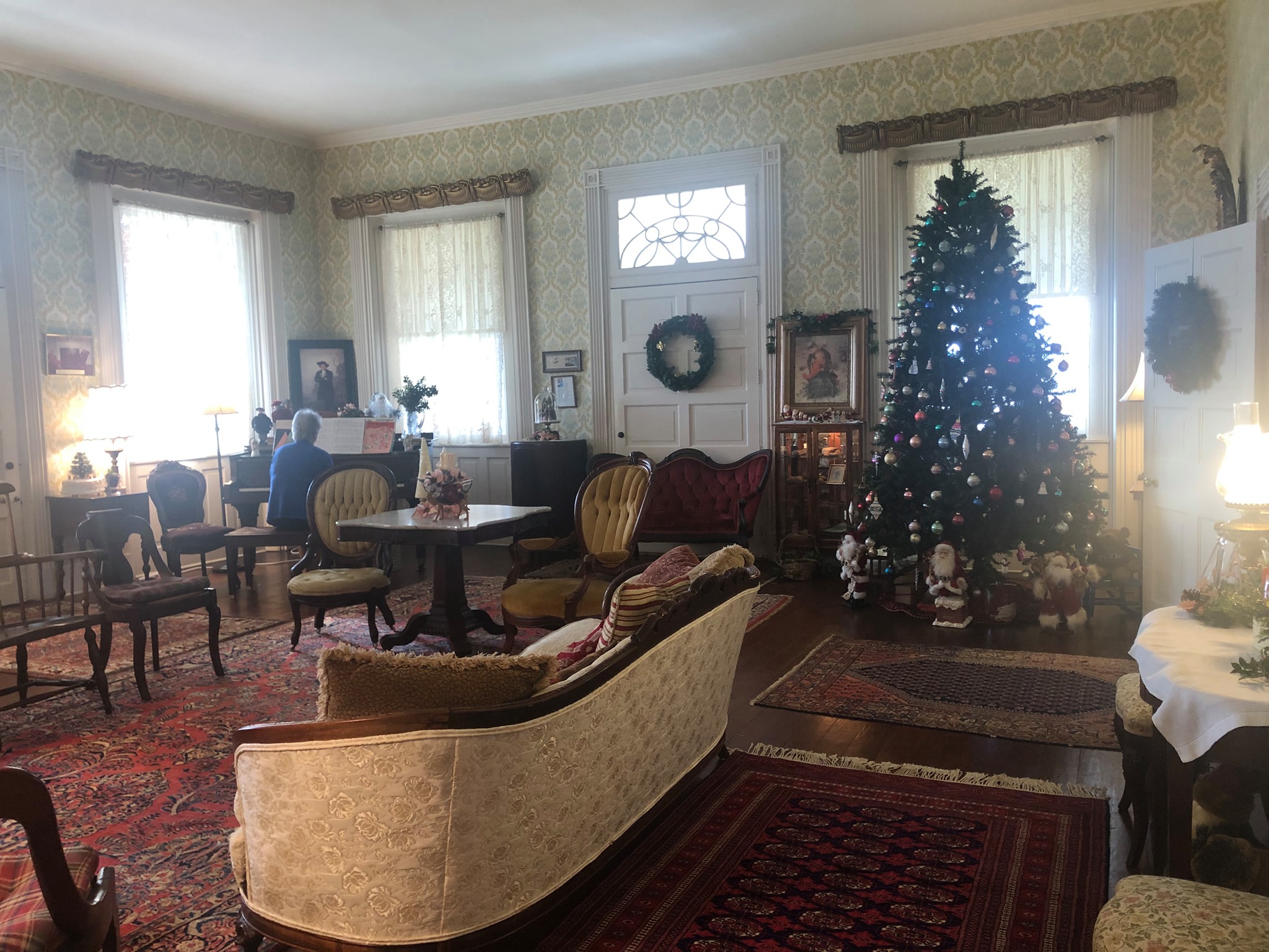 The front porch at Mount Oval with antique dolls, a wicker pram and children’s toys